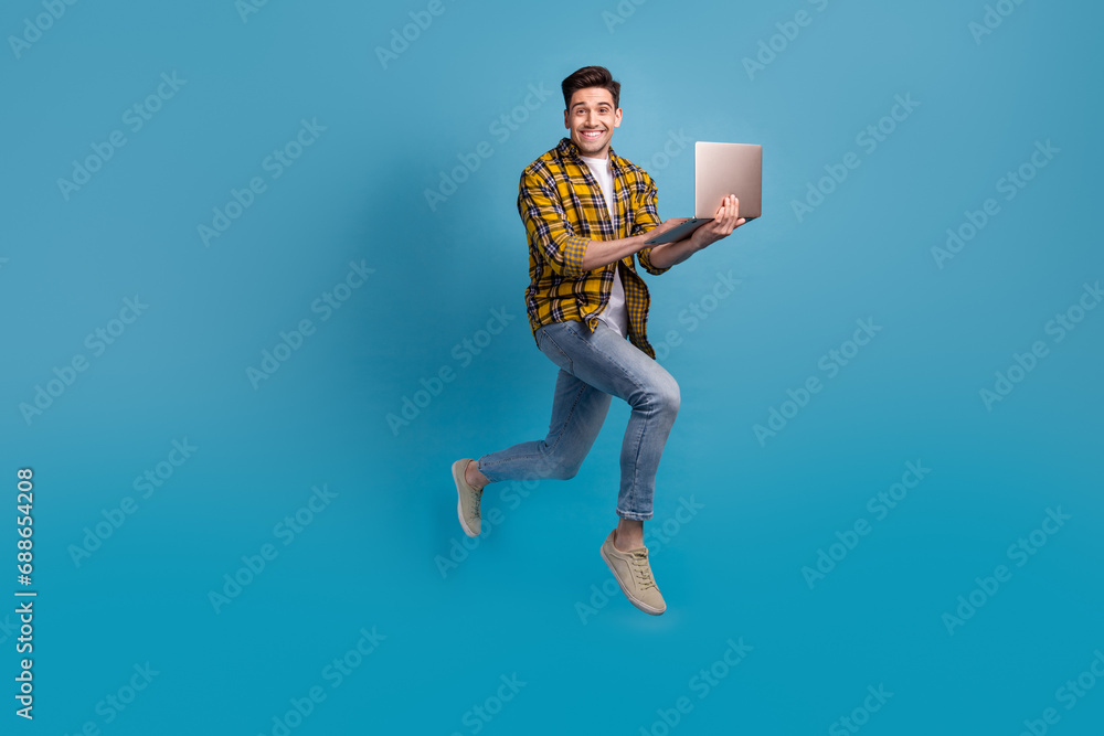 Full length photo of man just learned new code language future programmer running to employers with laptop isolated on blue color background Full length photo of man just learned new code language future programmer running to employers with laptop isolated on blue color background
