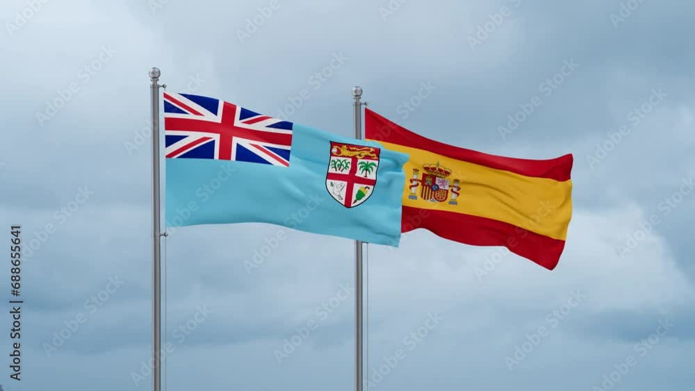 Spain and Fiji flag waving together on cloudy sky, endless seamless loop, two country cooperation concept Spain and Fiji flag waving together on cloudy sky, endless seamless loop, two country cooperation concept
