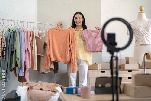 Asian Woman dressmaker working in fashion studio design and shipping an online order with woman sending package  online consulting at clothing shop