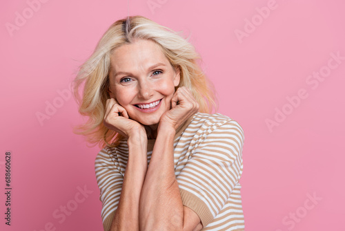 Photo of cute positive pensioner lady enjoy dermatology skin care procedure face lifting isolated on pink color background