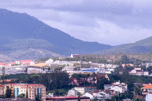 View on roofs in the city of Dalat. Da Lat and the surrounding area is a popular tourist destination of Asia. City with fogs and mountains © CravenA