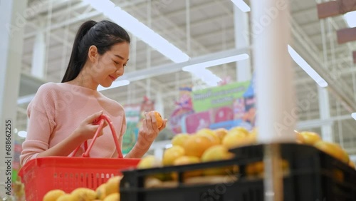 Shopping concepts of 4k Resolution. Asian women shopping for fruit in a mall.