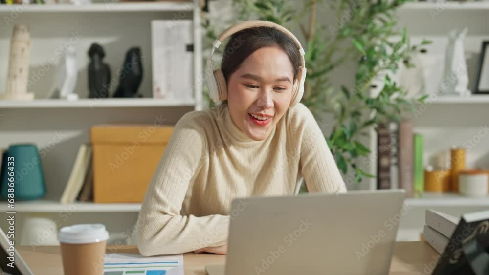 smiling asian adult female video calling online conversation with friend cheerful relax relation woman using laptop and headphone talking fun relax positive good vibes at home stay home lifestyle smiling asian adult female video calling online conversation with friend cheerful relax relation woman using laptop and headphone talking fun relax positive good vibes at home stay home lifestyle