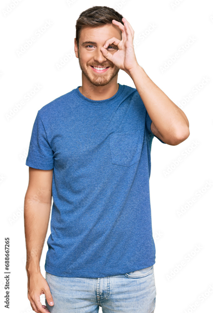 Handsome caucasian man wearing casual clothes doing ok gesture with hand smiling, eye looking through fingers with happy face. Handsome caucasian man wearing casual clothes doing ok gesture with hand smiling, eye looking through fingers with happy face.