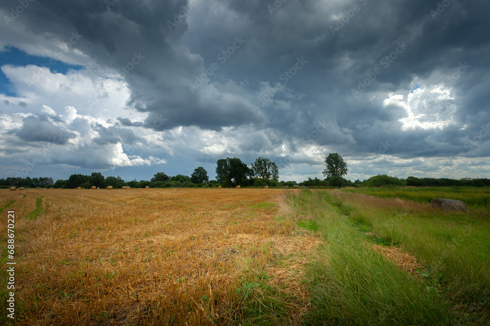 Dark rainy clouds over the fields