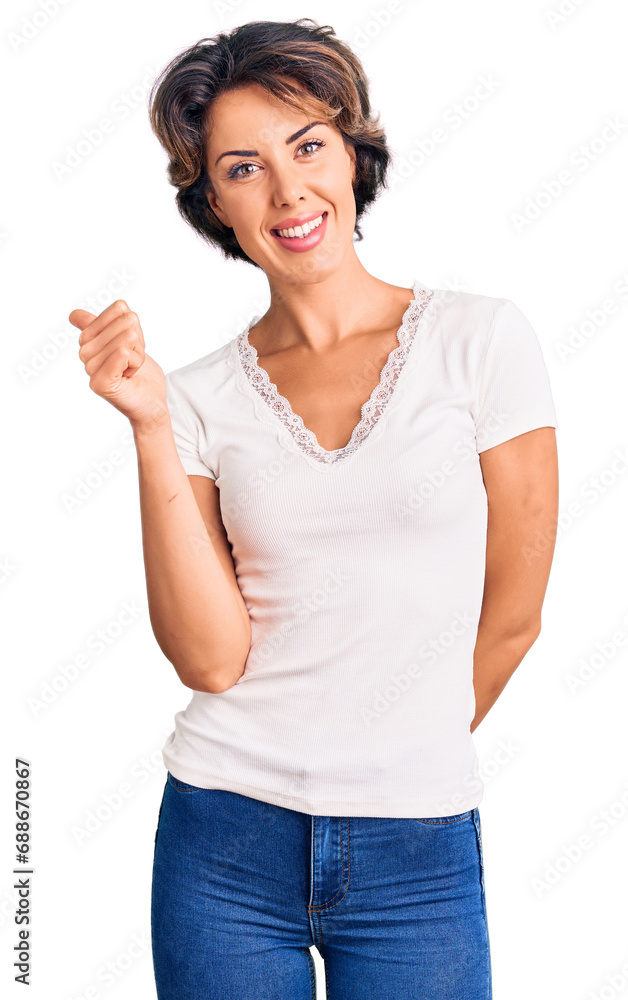 Young beautiful woman wearing casual clothes smiling happy and positive, thumb up doing excellent and approval sign Young beautiful woman wearing casual clothes smiling happy and positive, thumb up doing excellent and approval sign