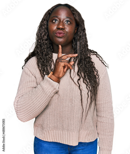 Fotografie Young african woman wearing wool winter sweater thinking concentrated about doub