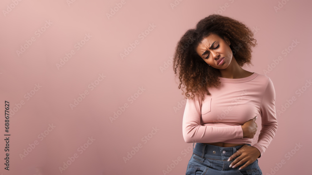 Afro american woman wincing in pain and hand rubbing stomach Afro american woman wincing in pain and hand rubbing stomach