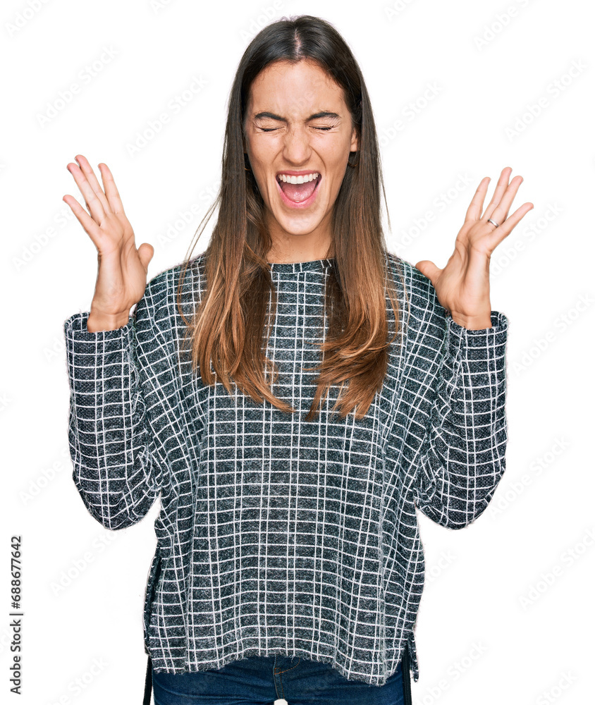 Young beautiful woman wearing casual clothes celebrating mad and crazy for success with arms raised and closed eyes screaming excited. winner concept Young beautiful woman wearing casual clothes celebrating mad and crazy for success with arms raised and closed eyes screaming excited. winner concept