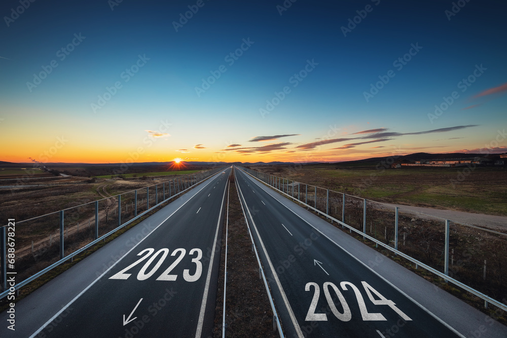 Fototapeta premium Driving on open road at beautiful sunny day to new year 2024 Aerial view