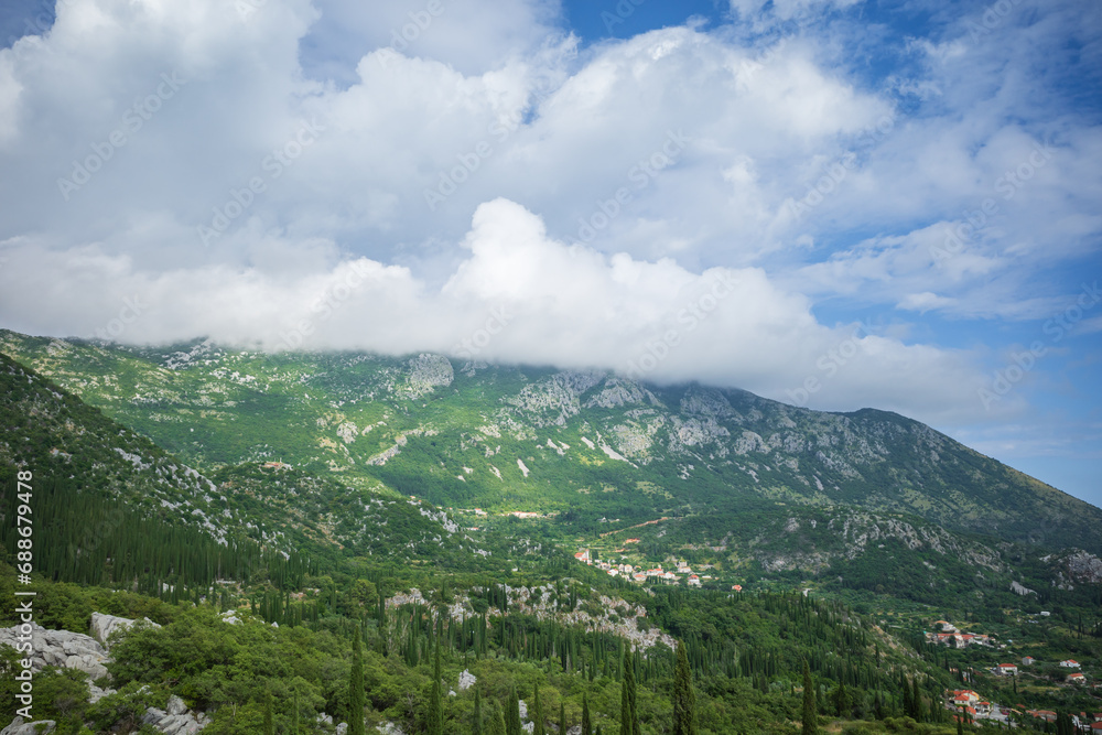 View from Sokol fortress, Croatia, to cliffs grown with green cypresses View from Sokol fortress, Croatia, to cliffs grown with green cypresses