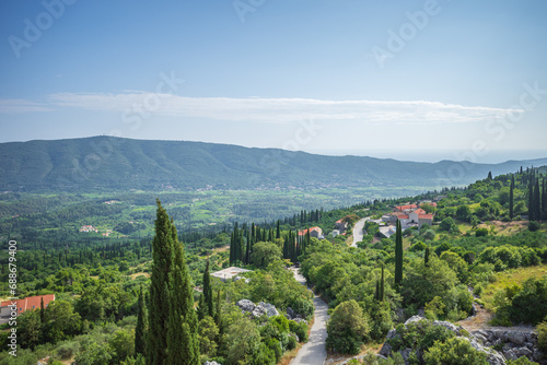 View from Sokol fortress, Croatia, to cliffs grown with green cypresses and road through the valley