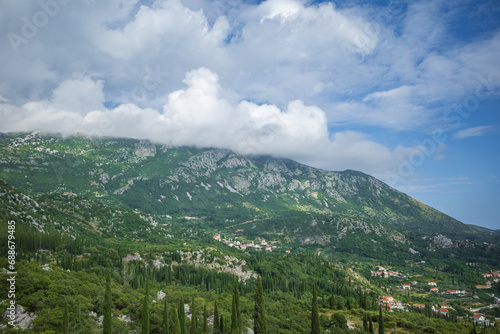 View from Sokol fortress  Croatia  to cliffs grown with green cypresses