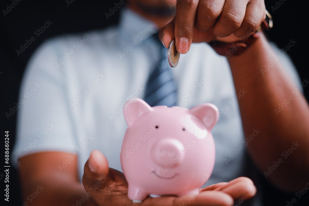 Financial concept, man holding piggy bank on wooden table Financial concepts, business, finance, investing, financial planning, investing for education Financial concept, man holding piggy bank on wooden table Financial concepts, business, finance, investing, financial planning, investing for education