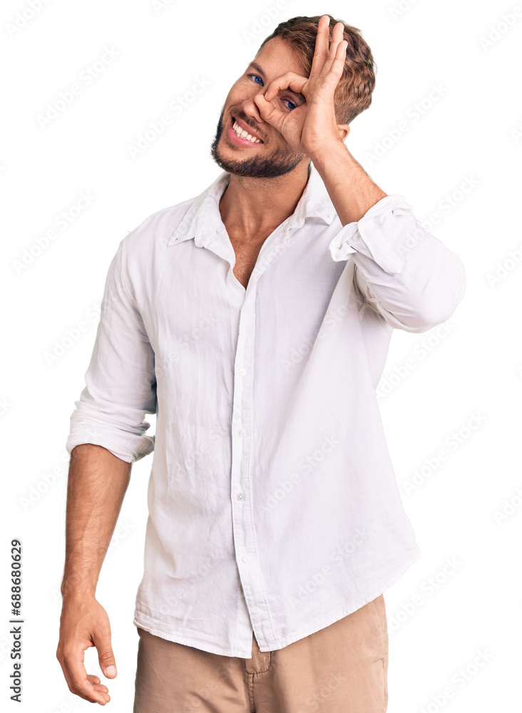 Young caucasian man wearing casual clothes doing ok gesture with hand smiling, eye looking through fingers with happy face. Young caucasian man wearing casual clothes doing ok gesture with hand smiling, eye looking through fingers with happy face.