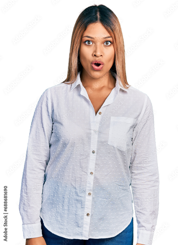 Young hispanic woman wearing casual white shirt afraid and shocked with surprise expression, fear and excited face. Young hispanic woman wearing casual white shirt afraid and shocked with surprise expression, fear and excited face.