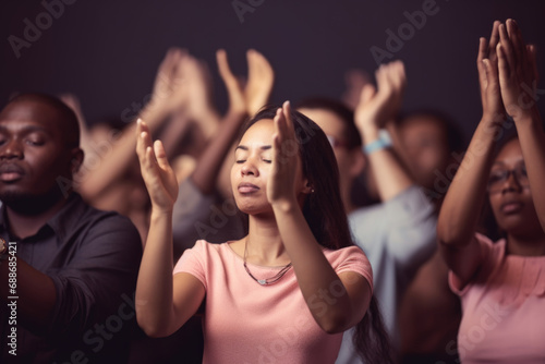 People with hands raised in prayer. Concept of collective worship and faith. photo