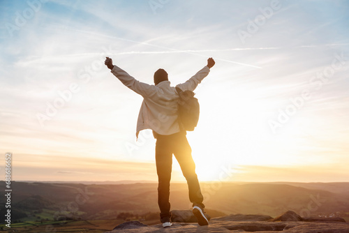 Silhouette enjoy back black man open arm love on sunset nature mountain  Positive yourself male success life concept breath passion wisdom wellbeing. photo