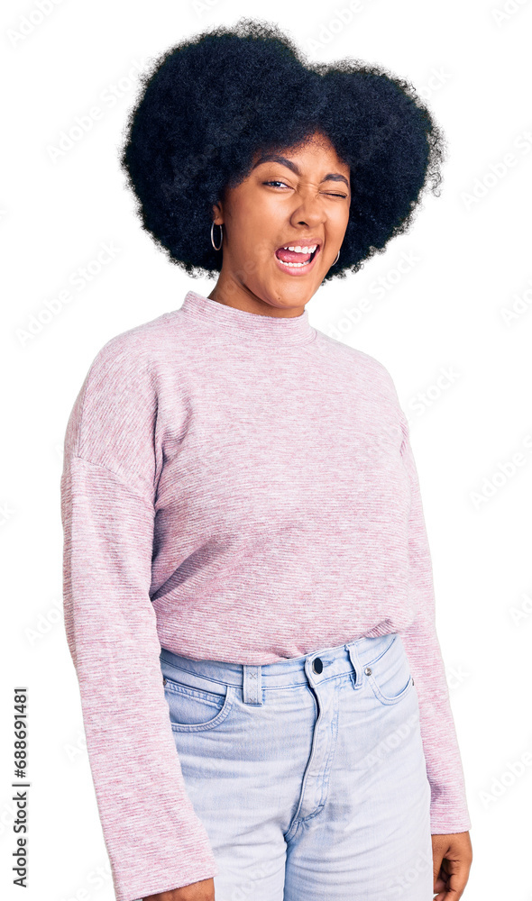 Young african american girl wearing casual clothes winking looking at the camera with sexy expression, cheerful and happy face. Young african american girl wearing casual clothes winking looking at the camera with sexy expression, cheerful and happy face.