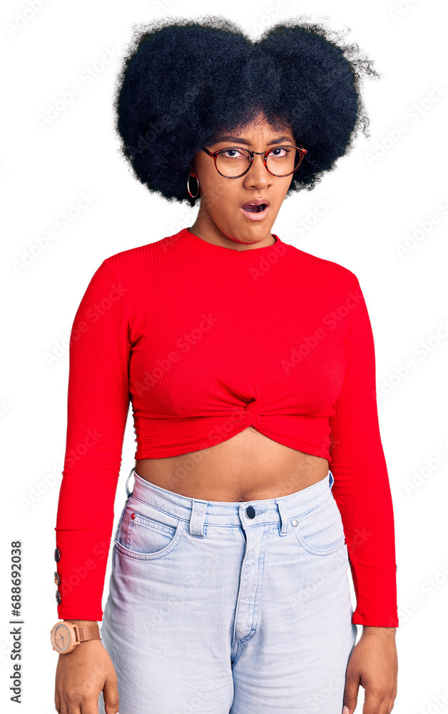 Young african american girl wearing casual clothes and glasses in shock face, looking skeptical and sarcastic, surprised with open mouth Young african american girl wearing casual clothes and glasses in shock face, looking skeptical and sarcastic, surprised with open mouth