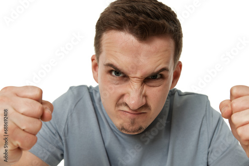angry guy looking at camera on white studio background