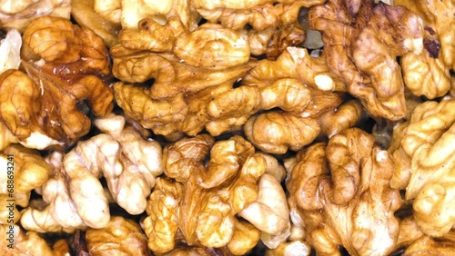 The walnuts are spinning. Top view. Close-up. View from above. Walnut fruits peeled from shell and husk. Healthy food. Edible nut seed. 4k footage video of bright and beautiful walnuts. Ripe walnuts
