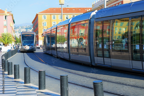 Trams in the center of Nice, France. Reflection of buildings in the windows of the tramway.