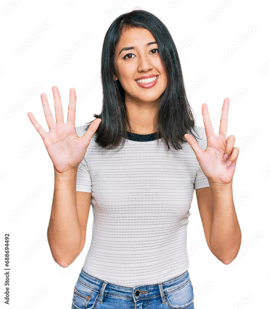 Beautiful asian young woman wearing casual white t shirt showing and pointing up with fingers number eight while smiling confident and happy. Beautiful asian young woman wearing casual white t shirt showing and pointing up with fingers number eight while smiling confident and happy.