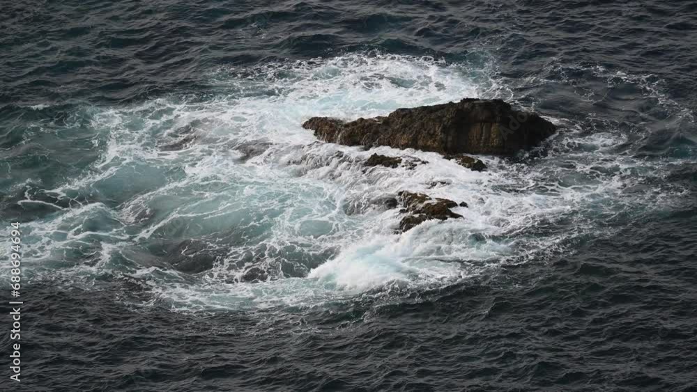 Dark dramatic Atlantic Ocean with waves breaking on the rocks dark blue Dark dramatic Atlantic Ocean with waves breaking on the rocks dark blue