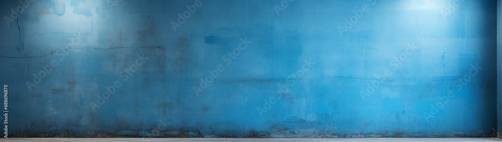 Fototapeta premium A wall corner painted in contrasting blues, one darker and the other lighter, deliberately creating a blank space for copy.