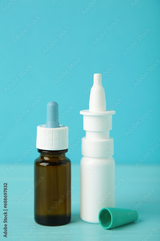 Bottles of nasal drops on blue background. Vertical photo Bottles of nasal drops on blue background. Vertical photo