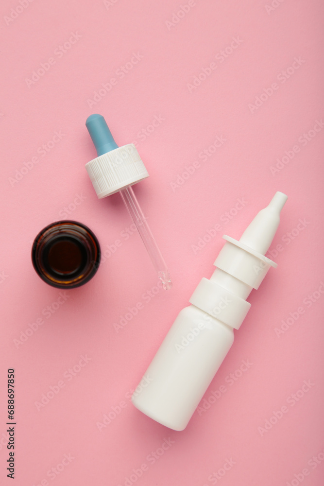 Bottles of nasal drops on pink background. Vertical photo Bottles of nasal drops on pink background. Vertical photo