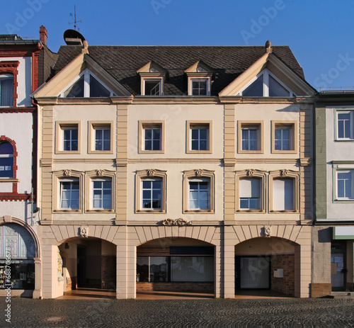 Historical facade of a neo-baroque apartment house with shop arcade in the old town of Kirchberg, Rheinland-Pfalz region in Germany