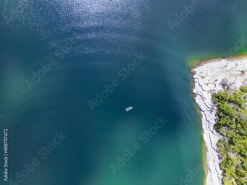 Drone picture from above of a boat on Lake Norfork, Arkansas, USA photo