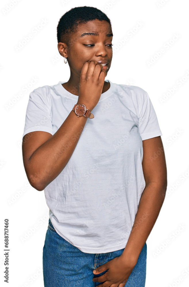 Young african american woman wearing casual white t shirt looking stressed and nervous with hands on mouth biting nails. anxiety problem. Young african american woman wearing casual white t shirt looking stressed and nervous with hands on mouth biting nails. anxiety problem.
