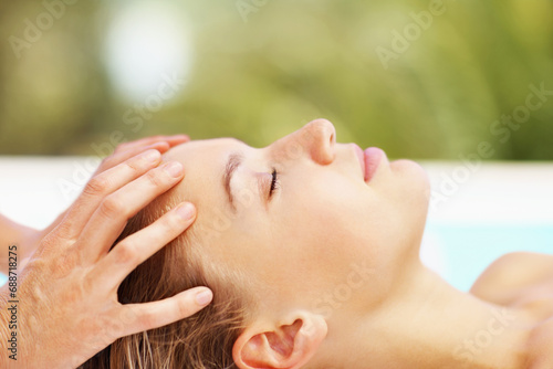 Woman, spa and head massage with therapist for wellness, holistic therapy and reiki at holiday resort. Beauty, skincare and profile of client relax for scalp acupressure, treatment or healing service photo