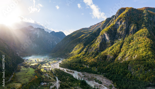 Aerial Panorama over Theth Village in the Northern Albanian Alps with Beautiful Sunbeams photo