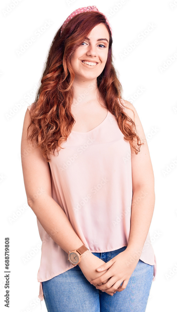 Young beautiful woman wearing casual clothes and diadem looking positive and happy standing and smiling with a confident smile showing teeth Young beautiful woman wearing casual clothes and diadem looking positive and happy standing and smiling with a confident smile showing teeth