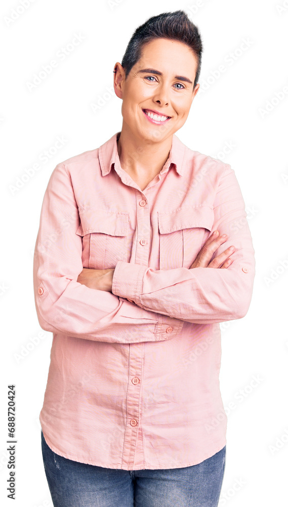 Young woman with short hair wearing casual clothes happy face smiling with crossed arms looking at the camera. positive person. Young woman with short hair wearing casual clothes happy face smiling with crossed arms looking at the camera. positive person.