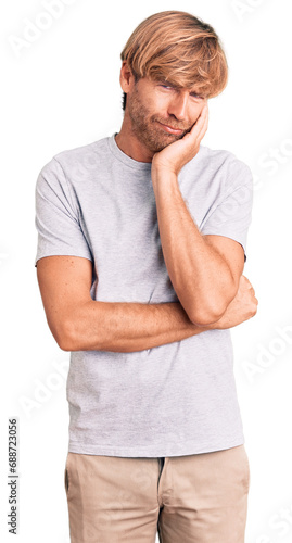 Handsome caucasian man with beard wearing casual tshirt thinking looking tired and bored with depression problems with crossed arms.