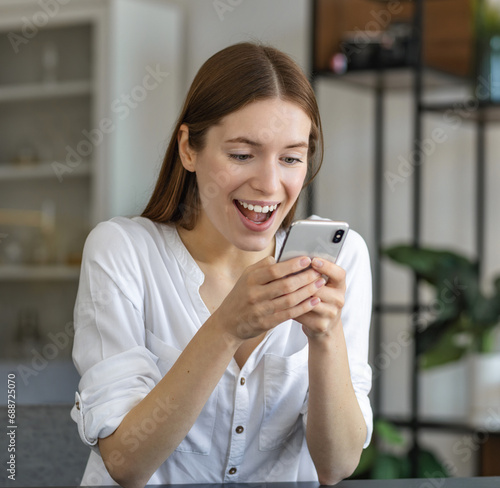 Happy young woman conducts online shopping, messaging friends, and shares posts on social media platform