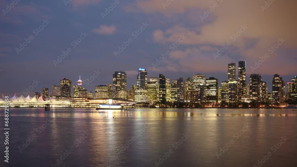 View of buildings illuminated in the city on coastline from stanley park at Vancouver View of buildings illuminated in the city on coastline from stanley park at Vancouver