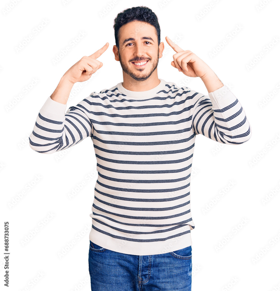 Young hispanic man wearing casual clothes smiling pointing to head with both hands finger, great idea or thought, good memory Young hispanic man wearing casual clothes smiling pointing to head with both hands finger, great idea or thought, good memory