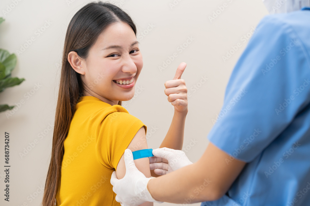 Healthcare of Covid-19, corona anti virus vaccination, happy asian young woman hand showing like at bandage, plaster on arm, getting vaccine immunity giving injection influenza to protection pandemic. Healthcare of Covid-19, corona anti virus vaccination, happy asian young woman hand showing like at bandage, plaster on arm, getting vaccine immunity giving injection influenza to protection pandemic.