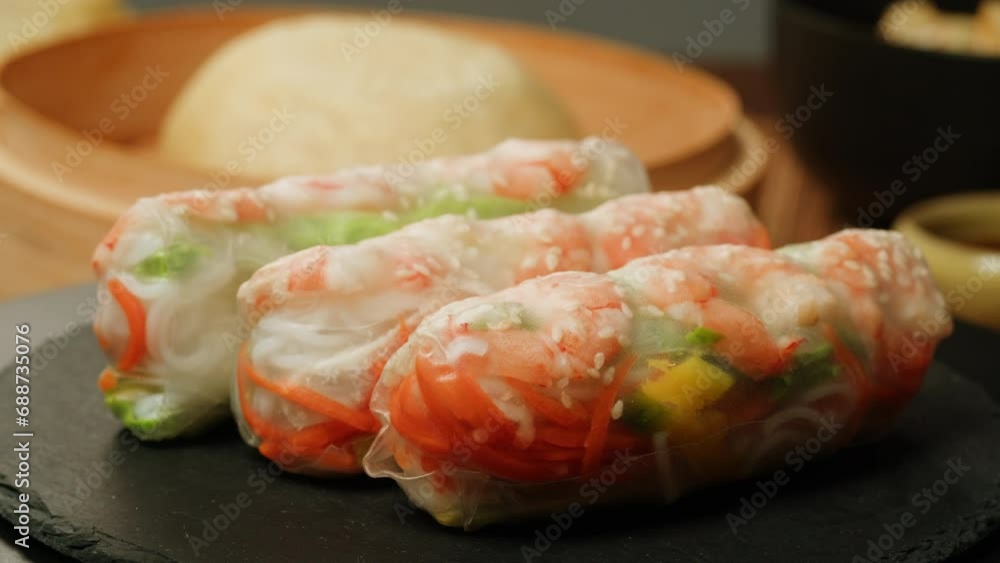 Spring roll with shrimps and vegetables inside close-up macro. Shrimp roll with rice papper. Cooking Fresh Vietnamese Spring Rolls. Healthy food. Spring roll with shrimps and vegetables inside close-up macro. Shrimp roll with rice papper. Cooking Fresh Vietnamese Spring Rolls. Healthy food.