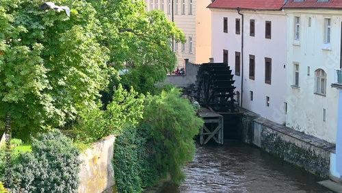 Prague,Czech Republic, August 4,2023. Beautiful view from the Charles Bridge towards the watermill on Kampa Island. Points of interest in the city. photo