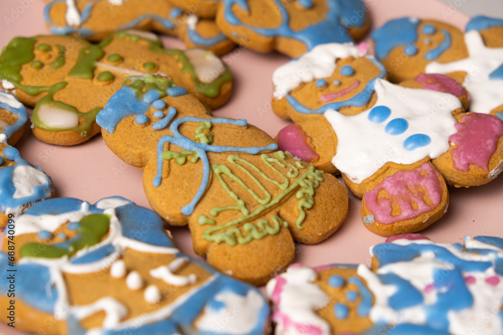 Christmas gingerbread in the shape of men decorated with colorful icing, top view