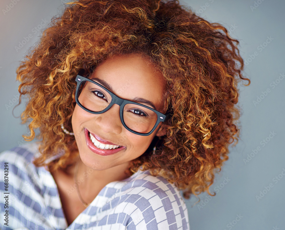Obraz premium Portrait, smile and business woman in glasses isolated on a gray background. Face, happy professional in spectacles and young creative designer, entrepreneur and employee working at startup in Brazil
