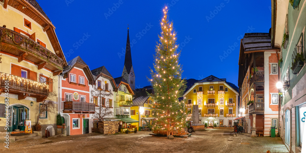 Naklejka premium Panorama of Christmas Market Square of Hallstatt mountain village in Austrian Alps at night, Austria