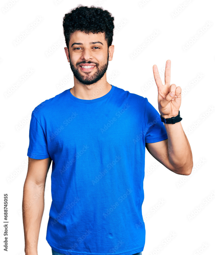 Young arab man with beard wearing casual blue t shirt showing and pointing up with fingers number two while smiling confident and happy. Young arab man with beard wearing casual blue t shirt showing and pointing up with fingers number two while smiling confident and happy.